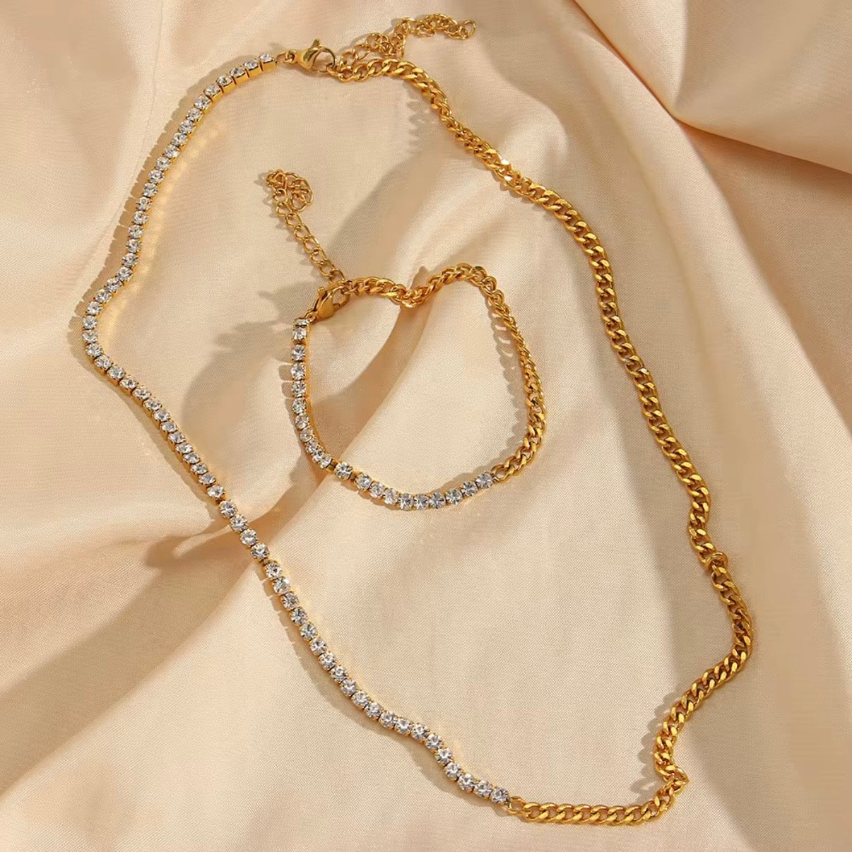 Gold bracelet with half CZ tennis strand and half gold curb chain displayed on soft beige fabric – hypoallergenic water and tarnish resistant bracelet