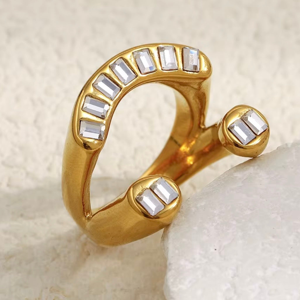 18k gold plated stainless steel open bypass arc ring with continuous channel-set baguette CZ arc and double baguette CZ rounded dome bypass ends, hypoallergenic tarnish resistant architectural statement ring by The Intertwined Collective