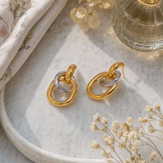 18k gold plated stainless steel double link chain drop earrings in gold and two-tone gold silver finish, hypoallergenic tarnish resistant statement earrings by The Intertwined Collective, Dallas Texas, displayed on a white marble tray with florals