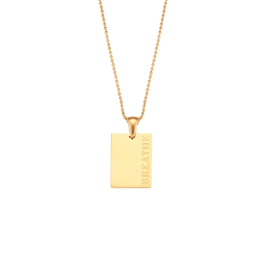 18k gold plated stainless steel affirmation tag pendant necklace on delicate ball chain with engraving options More Self Love, Made of Magic, Loved, and Breathe, hypoallergenic tarnish resistant meaningful gift necklace by The Intertwined Collective, Dallas Texas
