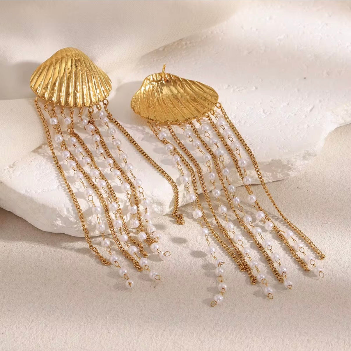 18k gold plated stainless steel ribbed seashell stud earrings with cascading pearl-beaded multi-strand gold chain fringe, hypoallergenic tarnish resistant coastal statement earrings by The Intertwined Collective, Dallas Texas
