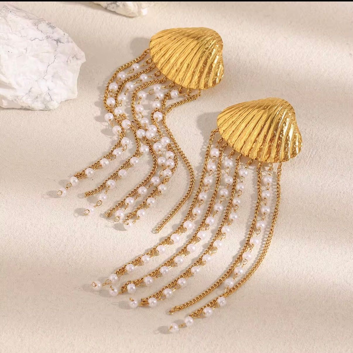 18k gold plated stainless steel ribbed seashell stud earrings with cascading pearl-beaded multi-strand gold chain fringe, hypoallergenic tarnish resistant coastal statement earrings by The Intertwined Collective, Dallas Texas
