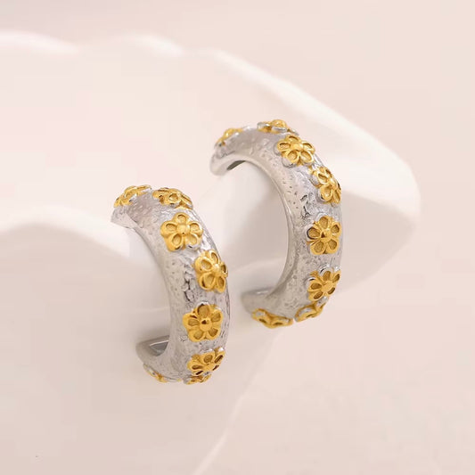 Gold textured huggie hoop earrings with raised floral pattern and tiny crystal accents on black earring card – hypoallergenic, water- and tarnish‑resistant mini hoops