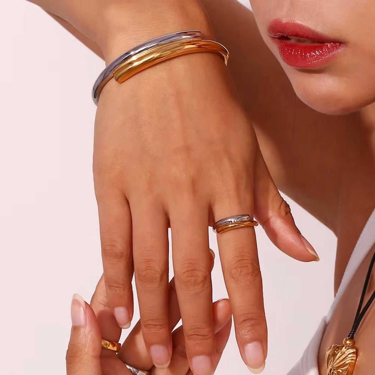 Two‑tone open band ring with overlapping high‑polish silver and gold arcs displayed on crinkled brown paper – hypoallergenic water and tarnish resistant mixed metal ring