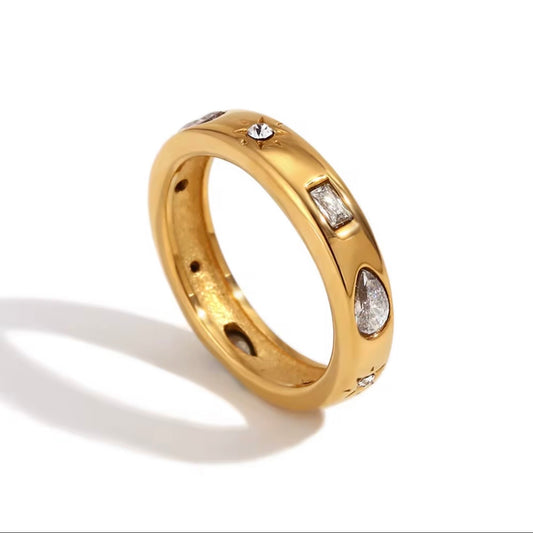 Gold celestial band ring with mixed-cut CZ accents including pear, baguette and star-set stones on white background – hypoallergenic water and tarnish resistant crystal ring