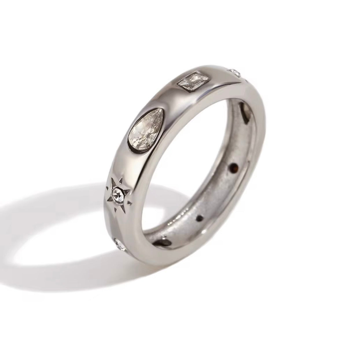 Silver celestial band ring with mixed-cut CZ accents including pear, baguette and star-set stones on white background – hypoallergenic tarnish resistant crystal ring
