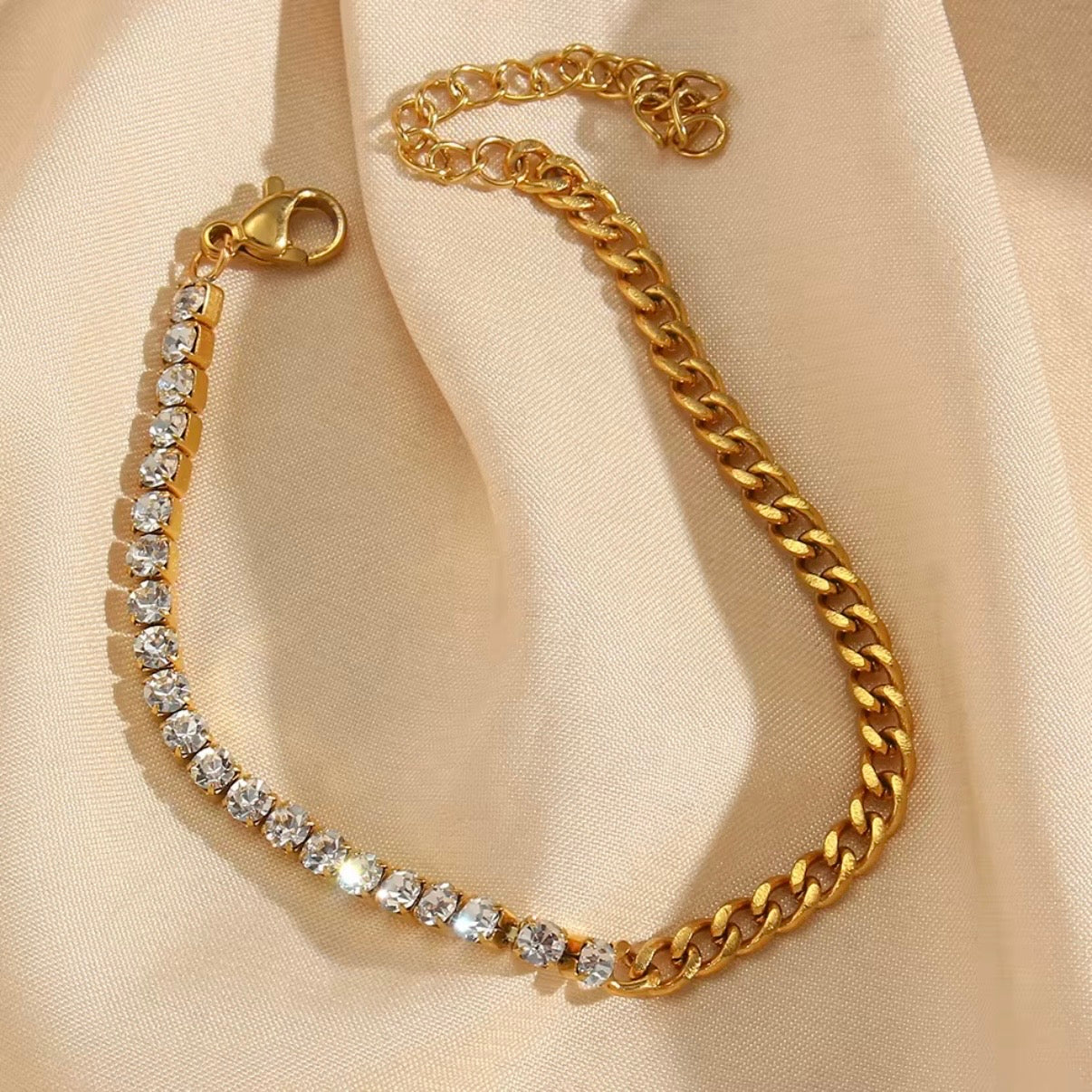 Gold bracelet with half CZ tennis strand and half gold curb chain displayed on soft beige fabric – hypoallergenic water and tarnish resistant bracelet