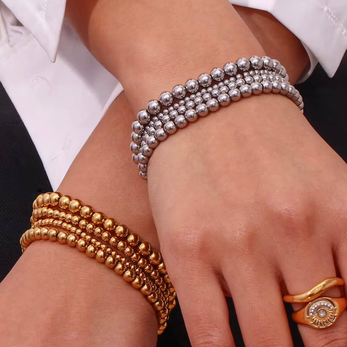 Gold and silver stretch bead bracelets in  3, 4, 5 and 6 mm sizes stacked together on soft fabric – hypoallergenic water and tarnish resistant beaded bracelets