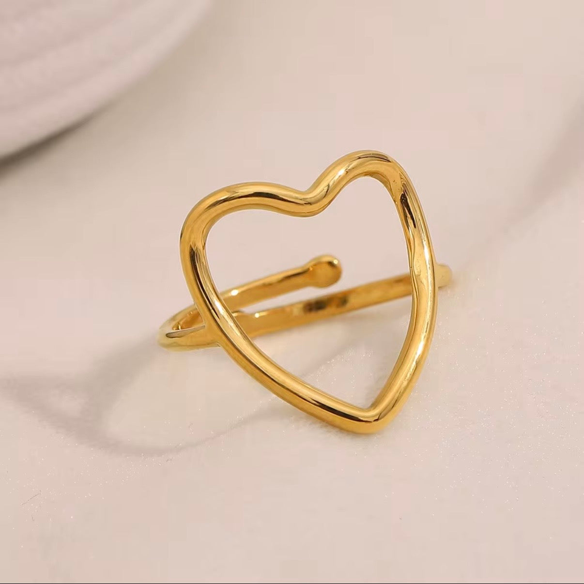 18k gold plated stainless steel open heart outline ring with oversized high-polish wire heart silhouette on a slim delicate band, hypoallergenic tarnish resistant minimalist romantic ring by The Intertwined Collective
