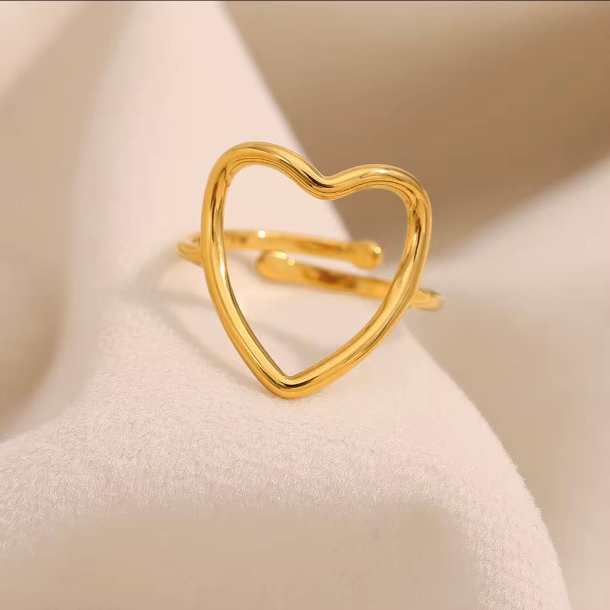 18k gold plated stainless steel open heart outline ring with oversized high-polish wire heart silhouette on a slim delicate band, hypoallergenic tarnish resistant minimalist romantic ring by The Intertwined Collective
