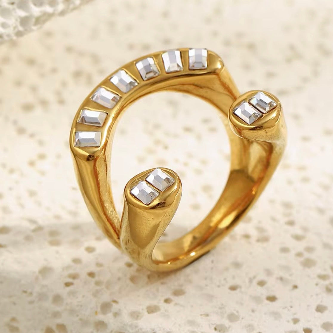 18k gold plated stainless steel open bypass arc ring with continuous channel-set baguette CZ arc and double baguette CZ rounded dome bypass ends, hypoallergenic tarnish resistant architectural statement ring by The Intertwined Collective
