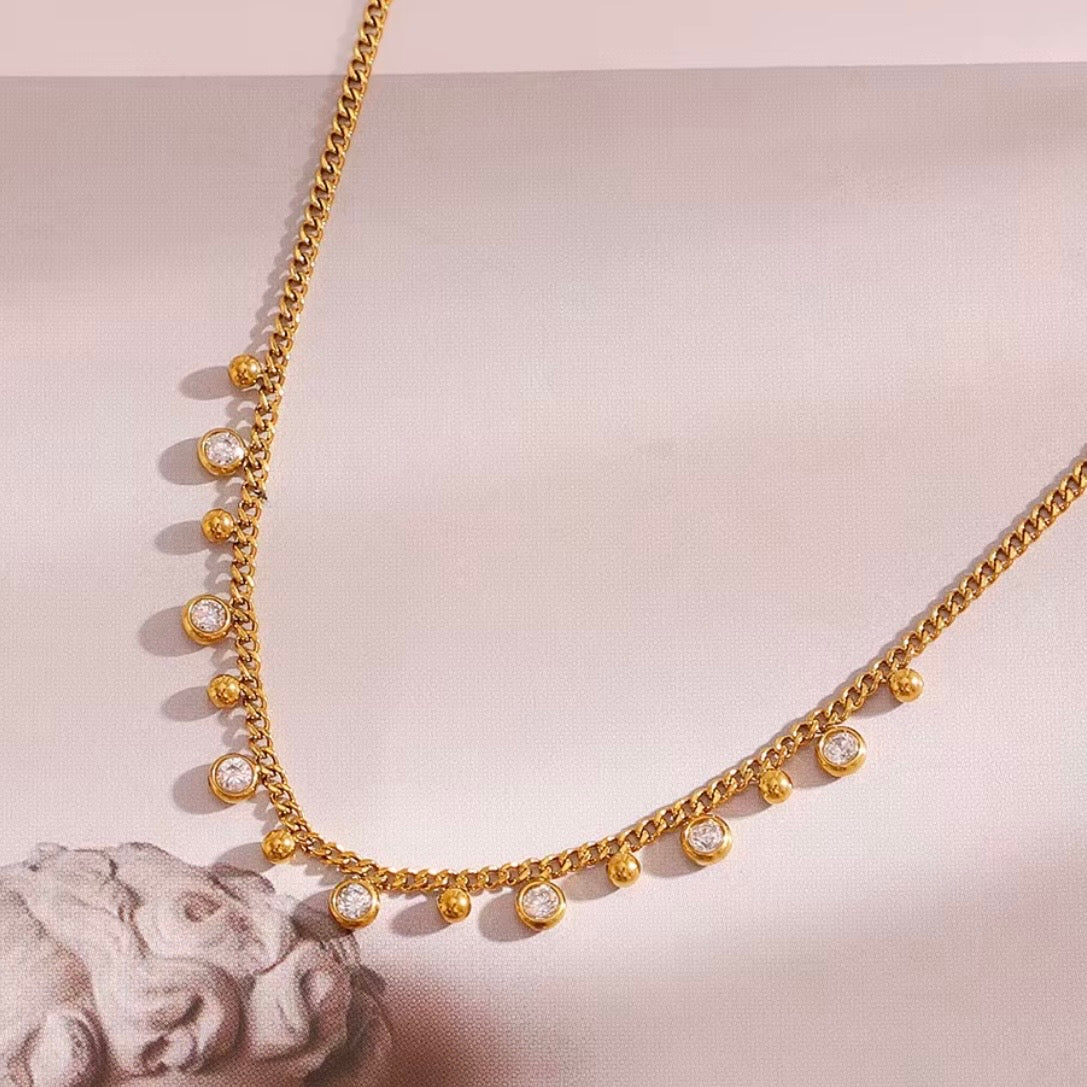 18k gold plated stainless steel curb chain necklace with alternating dangling round CZ bezel charms and polished gold ball charms along the front, hypoallergenic tarnish resistant charm fringe necklace by The Intertwined Collective
