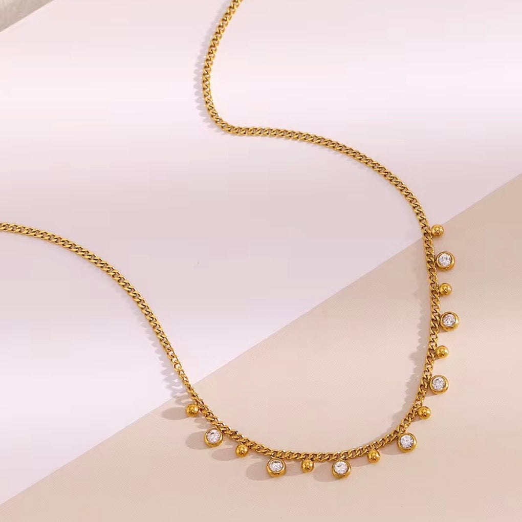 18k gold plated stainless steel curb chain necklace with alternating dangling round CZ bezel charms and polished gold ball charms along the front, hypoallergenic tarnish resistant charm fringe necklace by The Intertwined Collective

