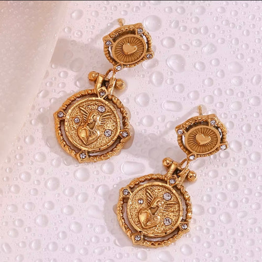 18k antiqued gold Sacred Heart coin drop earrings with CZ crystal square stud top and engraved winged heart medallion displayed on wet pearlescent surface — hypoallergenic water-resistant tarnish-resistant vintage statement earrings by The Intertwined Collective, Dallas Texas