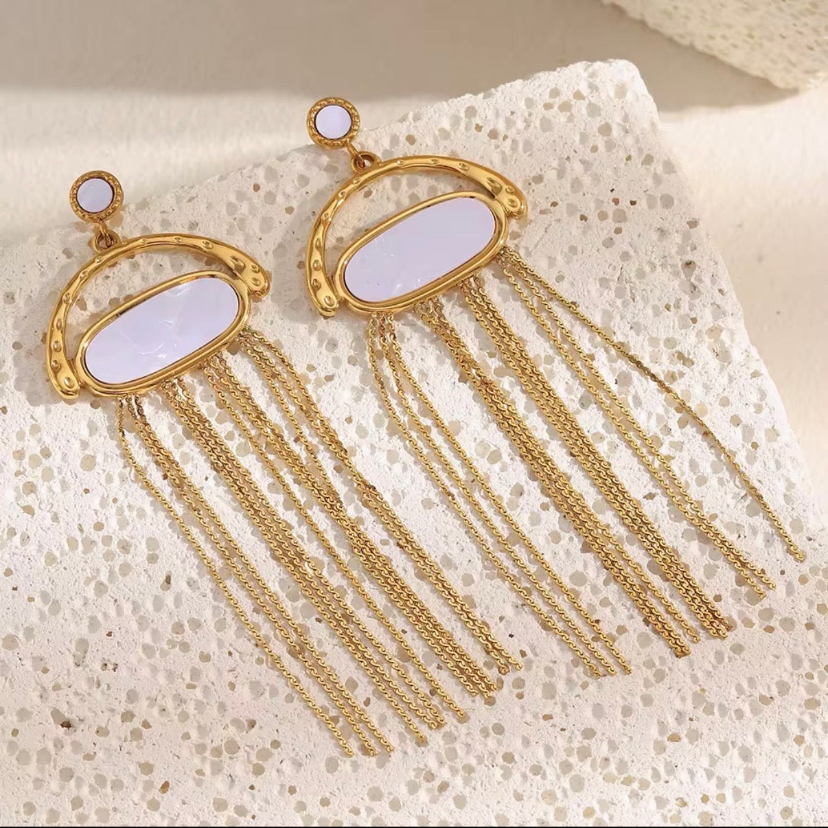 18k gold plated stainless steel white oval resin and gold arch frame earrings with cascading multi-strand chain fringe tassel, hypoallergenic tarnish resistant dramatic statement earrings by The Intertwined Collective, Dallas Texas