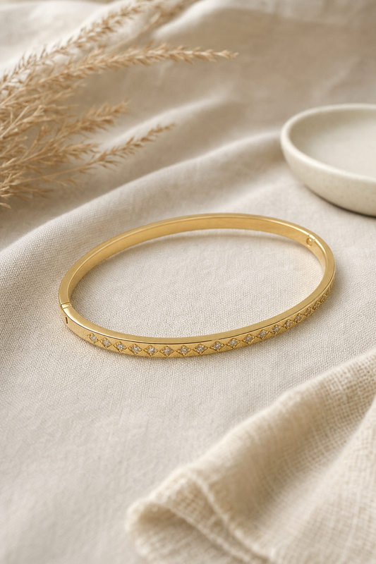 Gold diamond CZ bangle bracelet on linen with dried pampas grass